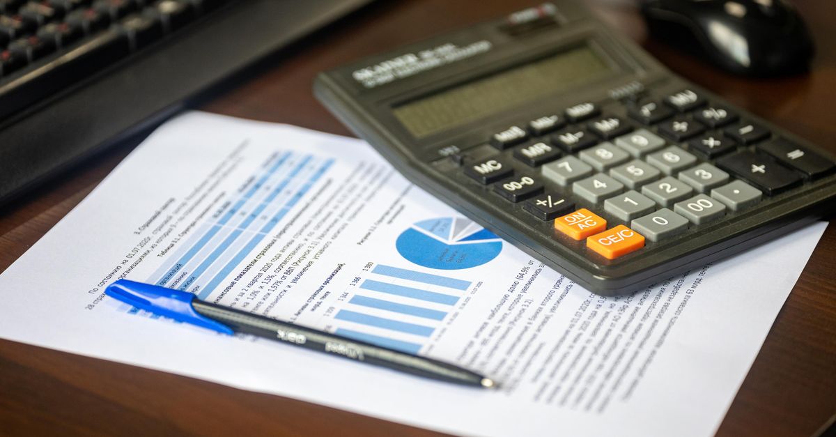 A calculator and a printed financial report on a desk