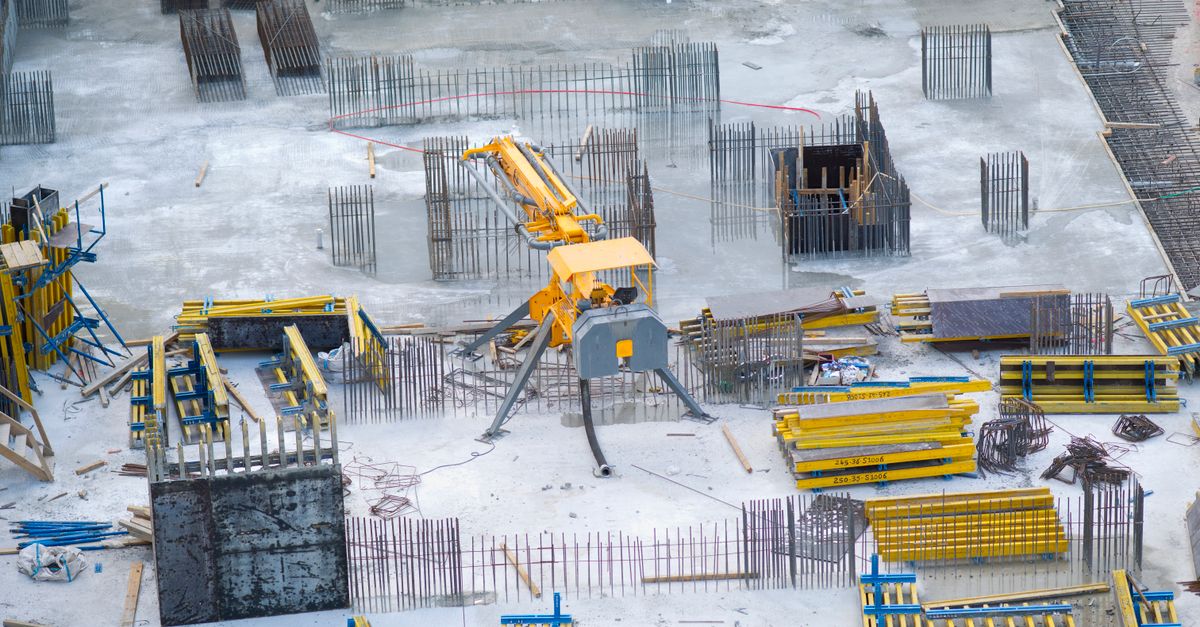 Aerial view of an active construction site with heavy machinery and materials