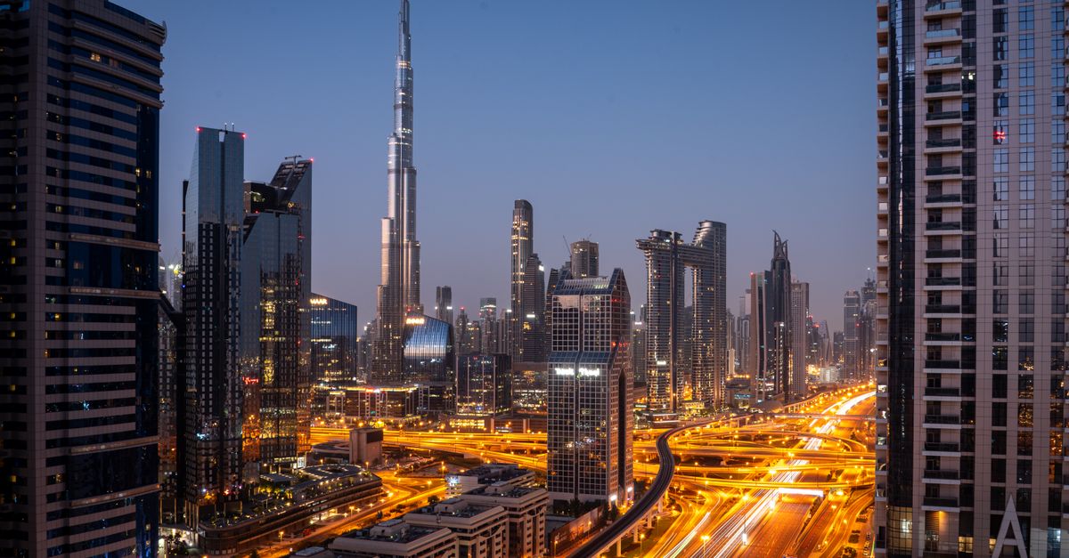 Downtown Dubai at dusk with the Burj Khalifa and busy roads lit up