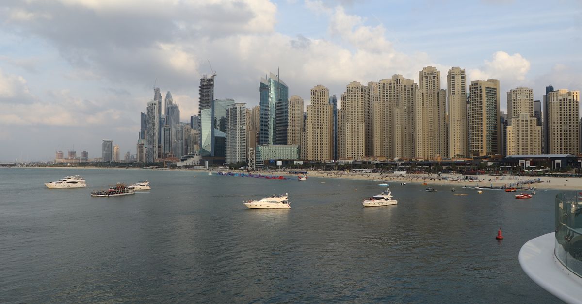 Apartment towers of Dubai Marina and JBR seen across the water with boats in the foreground