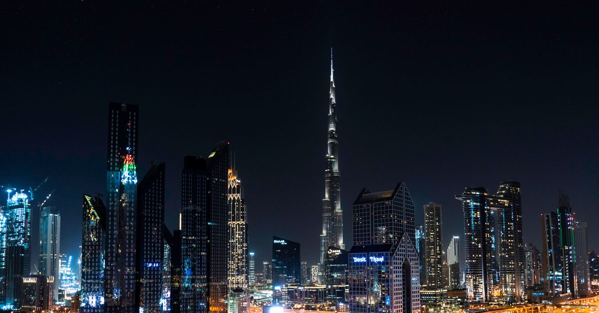 Dubai's illuminated skyline at night with the Burj Khalifa