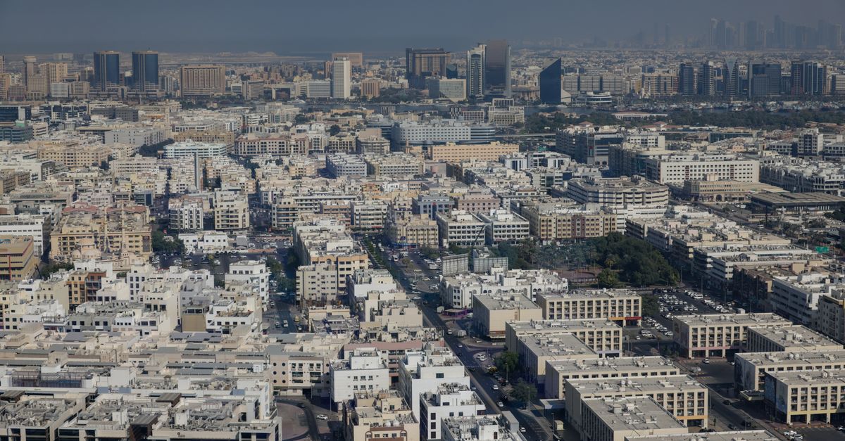Detailed aerial view of Dubai showing dense low-rise districts in front of the high-rise skyline