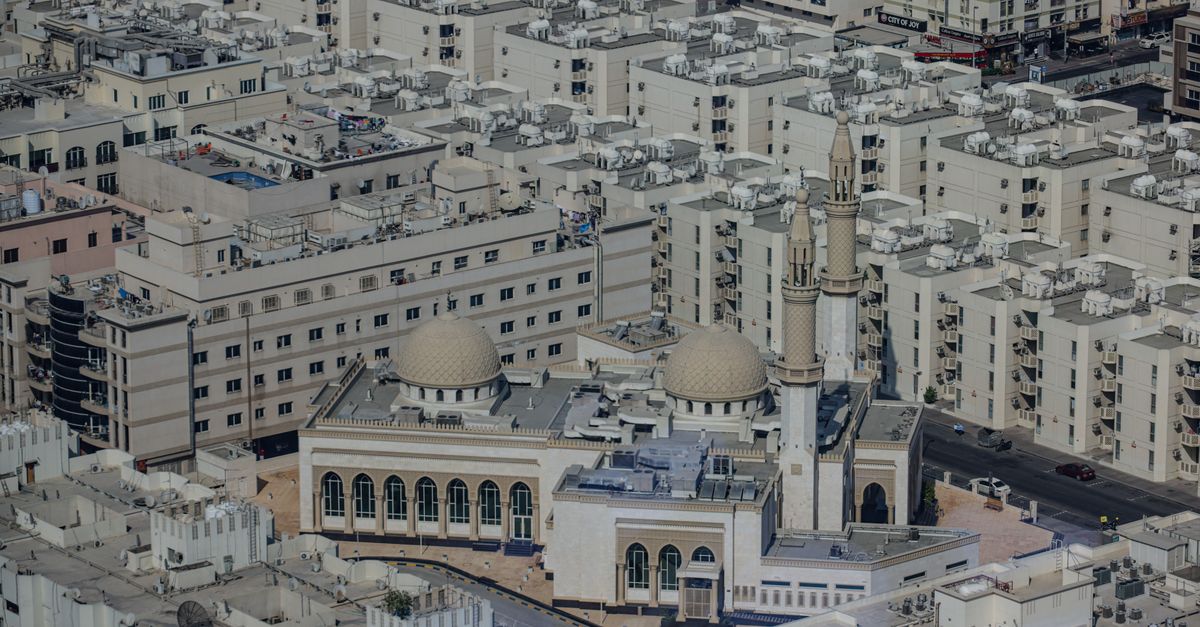 Aerial view of dense low-rise residential districts in Dubai around a mosque