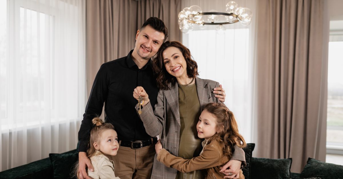 A family holding the keys to their new home