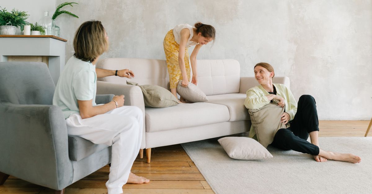 A family relaxing together in a bright, open-plan living room