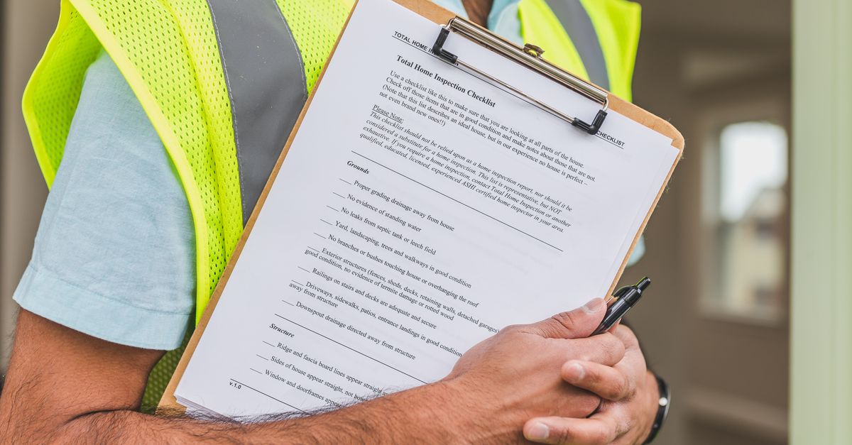 A clipboard holding a property inspection checklist