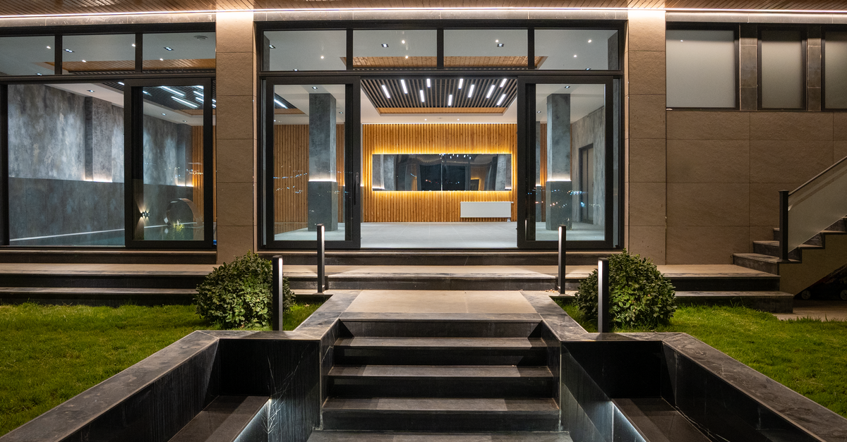 The illuminated entrance of a modern luxury house at night