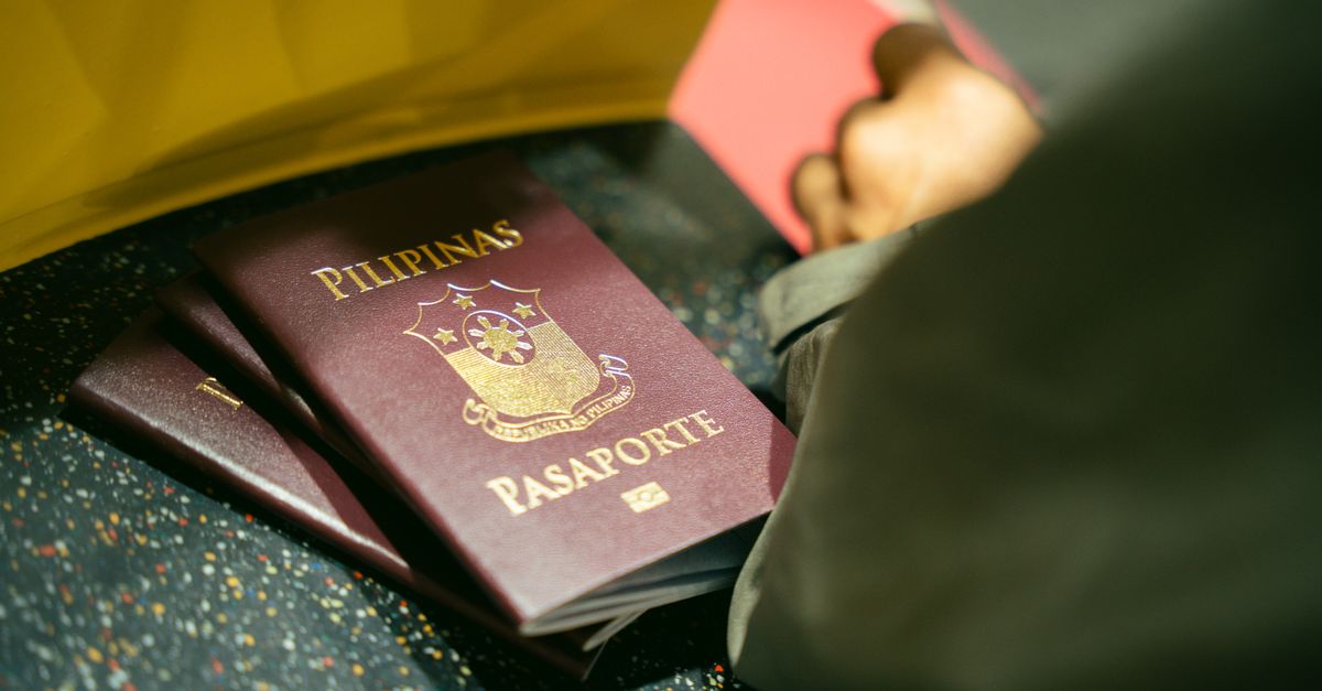 A traveller holding a passport at an airport
