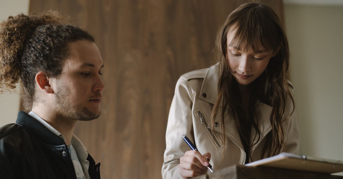 A young couple signing a tenancy contract together