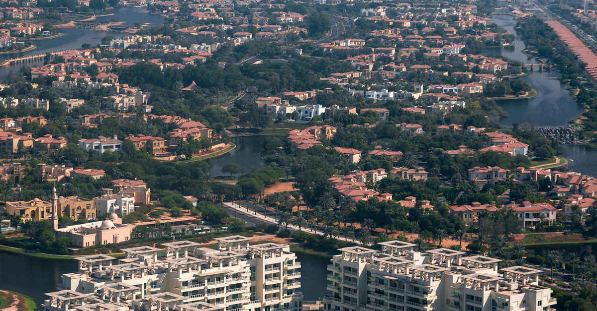 Aerial view of a waterfront villa community in Dubai